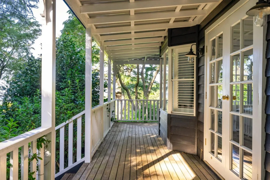 Cottage exterior with white door and timber verandah