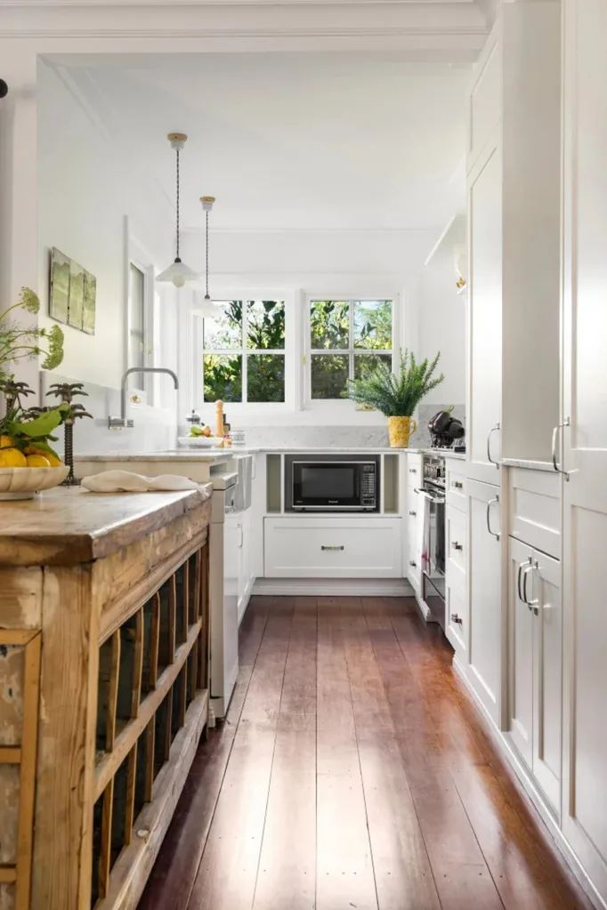 Southern Highlands home kitchen with white cabinets and timber floors