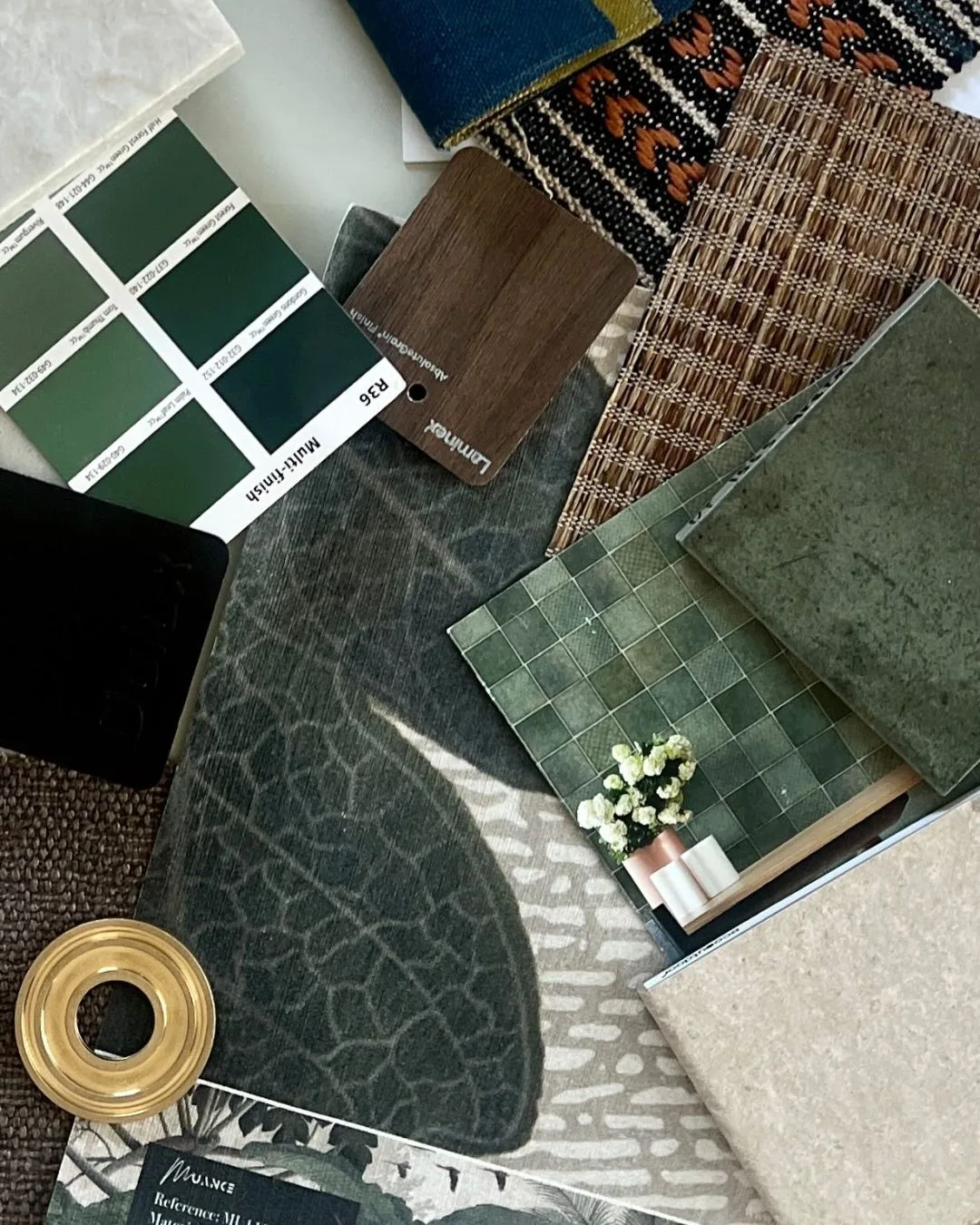 A renovation mood board for Deborah Hutton's south coast renovation, featuring forest green paint swatches, green tiles, brown fabric swatches and brass metal