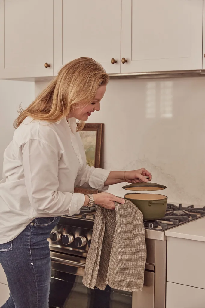 Elle Lovelock in her kitchen cooking on stove