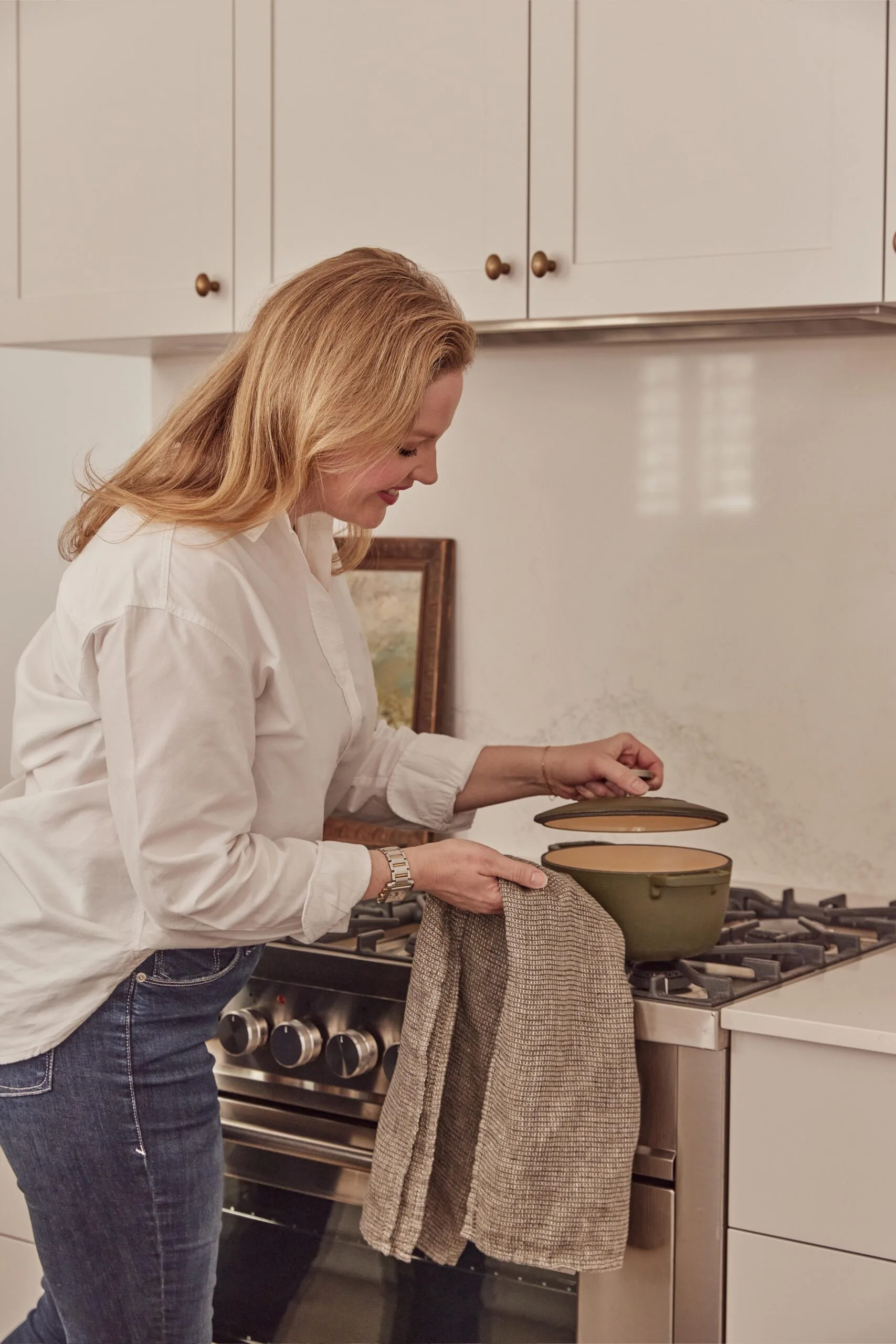 Elle Lovelock in her kitchen cooking on stove