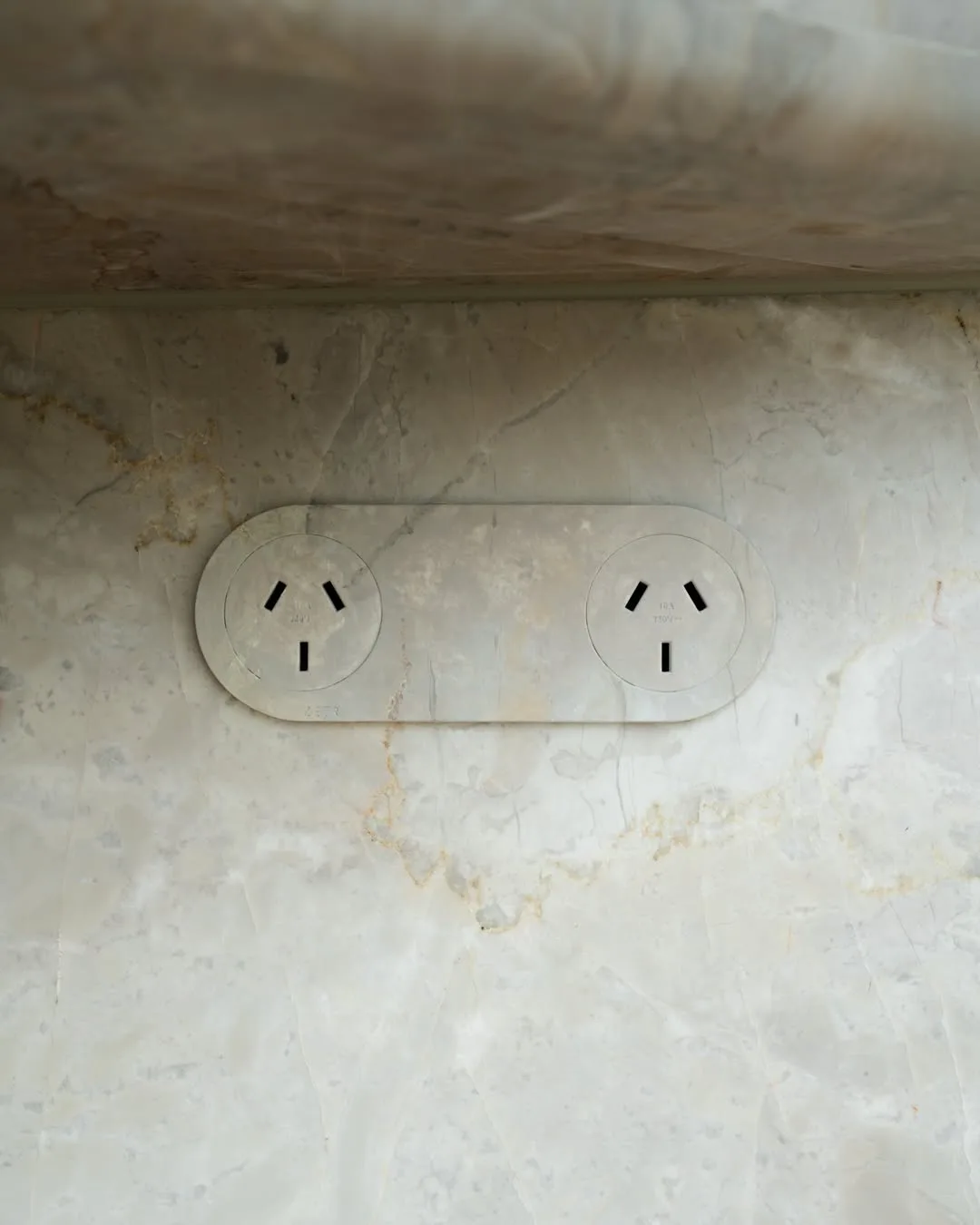 Kayla Itsines' adelaide home renovation wall plugs matching the stone