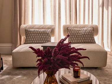 Steph and Gian's living room armchairs against sheer curtains