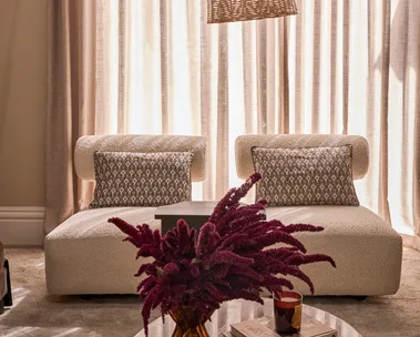 Steph and Gian's living room armchairs against sheer curtains