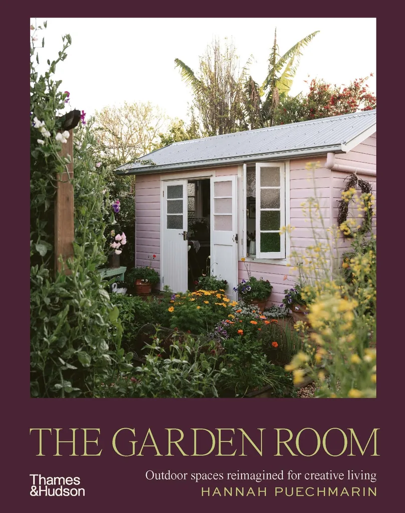 A book cover. The image depicts a pink shed, surrounded by flowers and bushes. The book title is 'The Garden Room: Outdoor Spaces Reimagined For Creative Living' by Hannah Puechmarin.