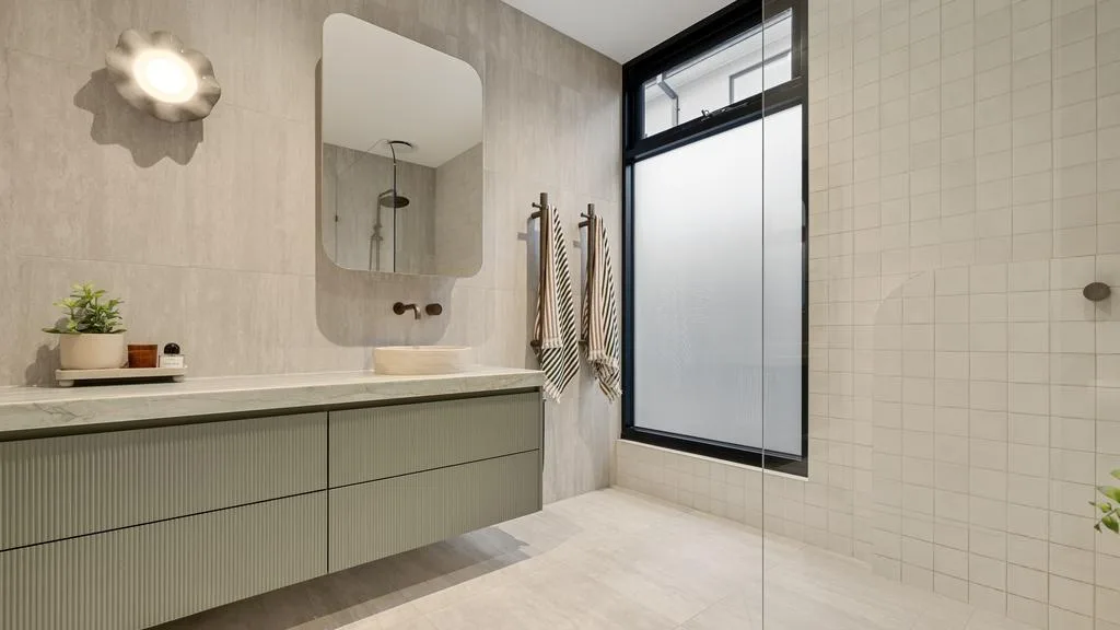 James Pattinson and wife Kayla's Black Rock home bathroom white tiles
