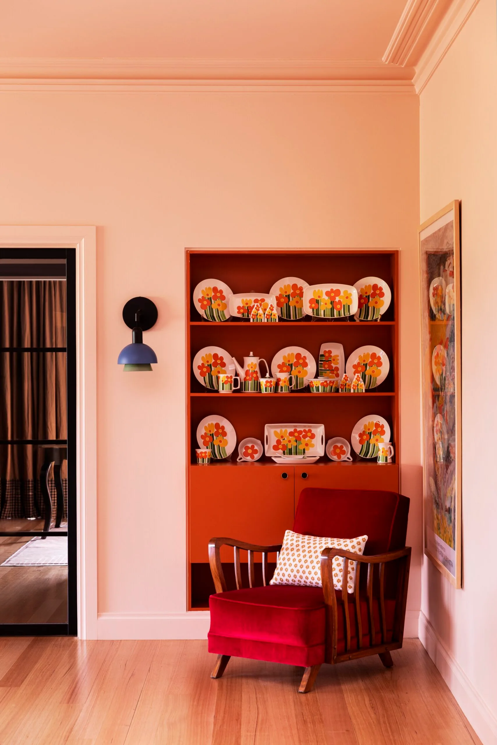 Yarra Valley home interior designer Carolyn Burns-McCrave red occasional chair colourful china shelf