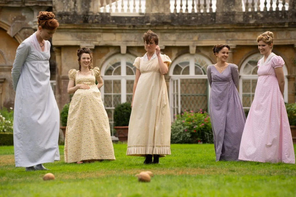 A still from period drama The Other Bennet Sister. Five sisters gather outside a Georgian home, on the lawn.