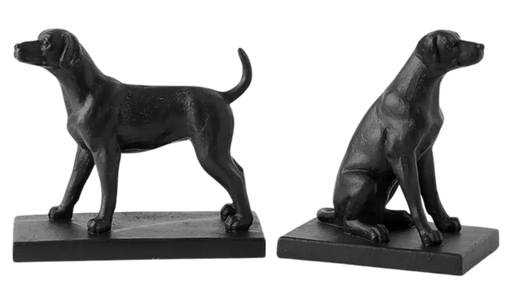 Two black bookends shaped like dogs. One is sitting and one is standing.