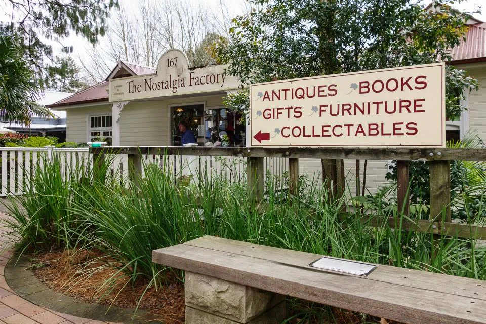 Shopfront of "The Nostalgia Factory" with a sign for antiques, books, gifts, furniture, and collectables.