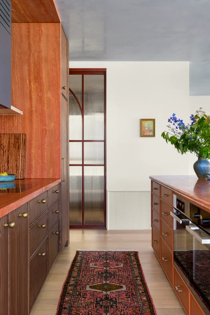Carlene Duffy Gold Coast apartment Surf Shack kitchen red travertine blue and walnut joinery rug