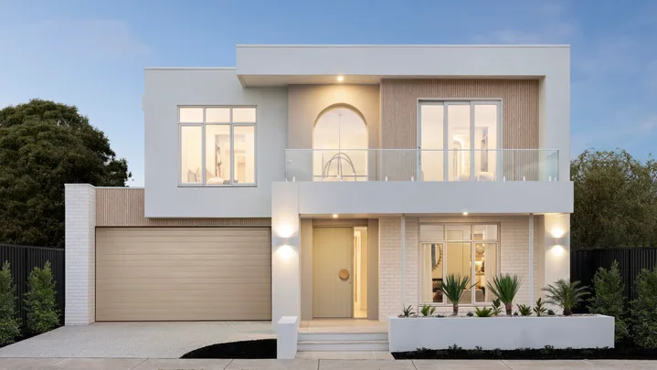 Modern two-story house with large windows, a light-colored facade, and a garage on the left side.