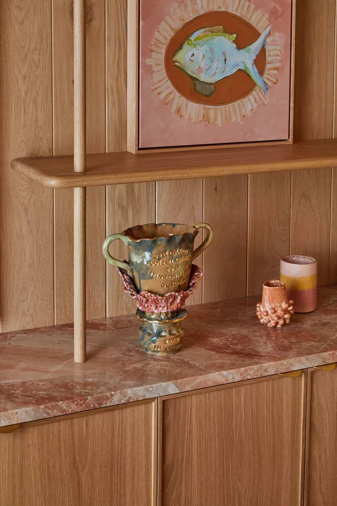 A ceramic vase sits atop a pink marble surface and American Oak timber cabinets in Patrick Dangerfield's home office.