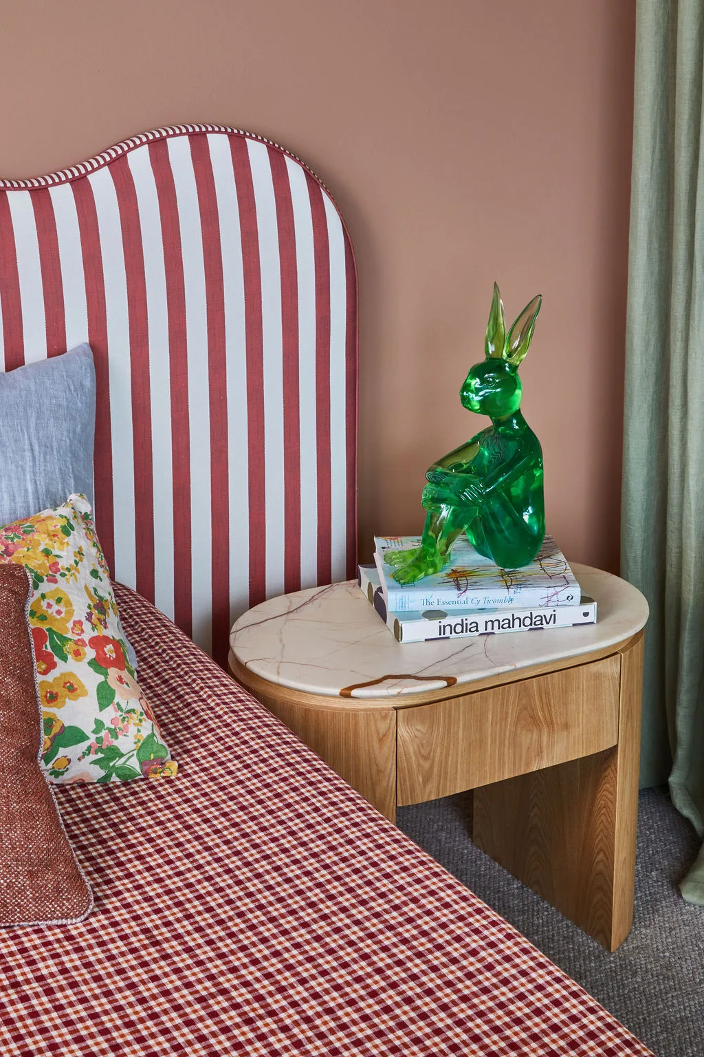 A small green Rabbitwoman sculpture by Gillie and Marc sits on a bedside table in Patrick Dangerfield's bedroom.