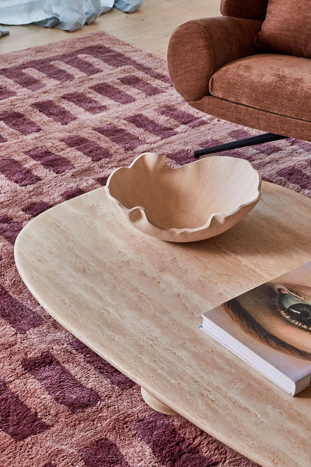 A close up of Patrick Dangerfield's marble coffee table with pink ceramic bowl and coffee table book