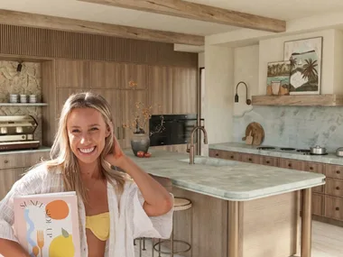 Sarah next to render of kitchen