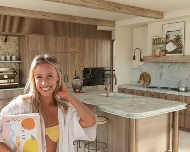 Sarah next to render of kitchen