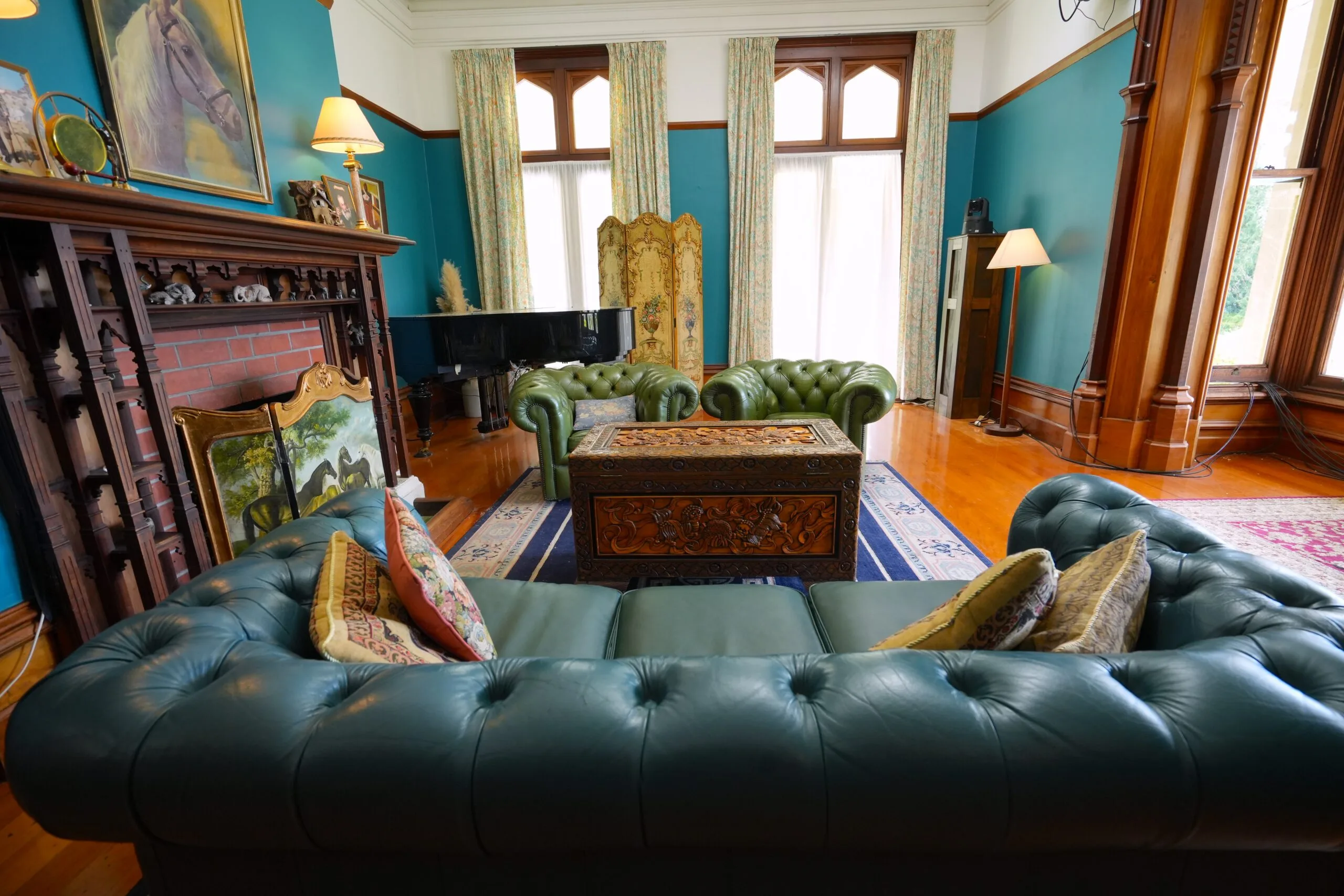 Historic carved timber fireplace with decorative mantel inside Castle Claremont.