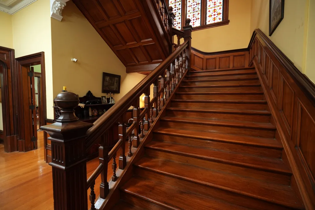 The grand timber staircase inside Castle Claremont, the historic New Zealand manor where The Traitors Australia season 3 was filmed.