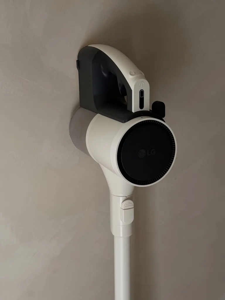 LG handheld vacuum cleaner mounted on a wall.