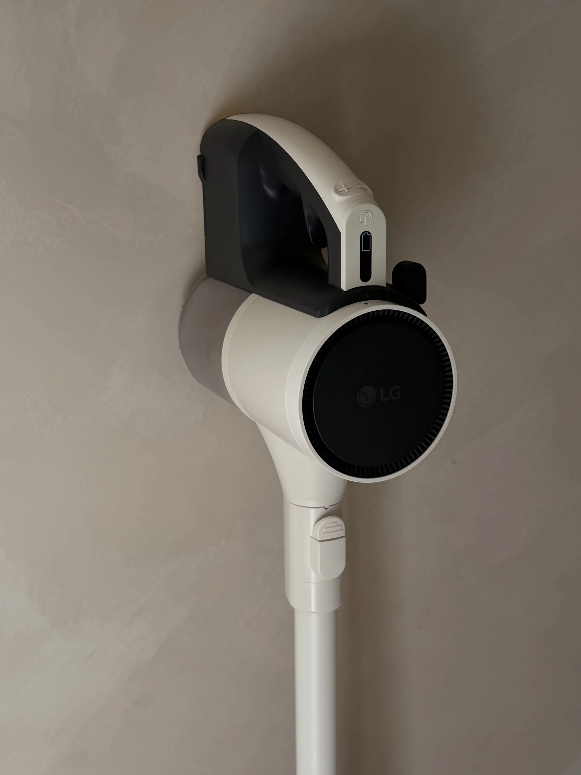 LG handheld vacuum cleaner mounted on a wall.