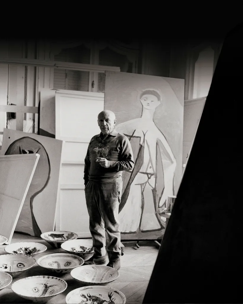 Pablo Picasso standing in his studio