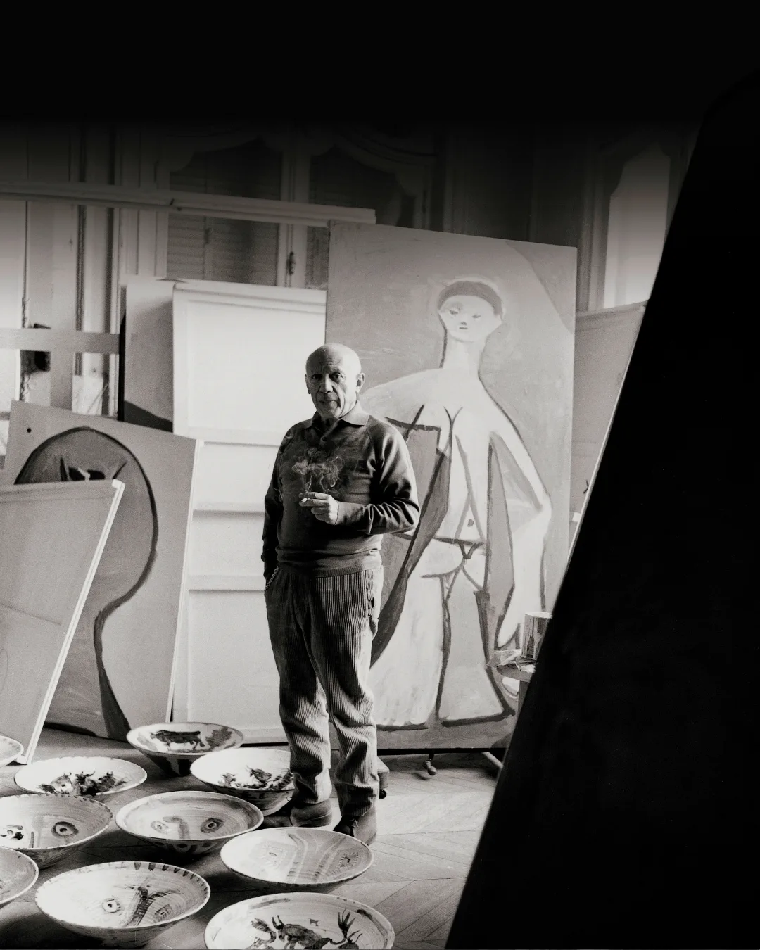 Pablo Picasso standing in his studio