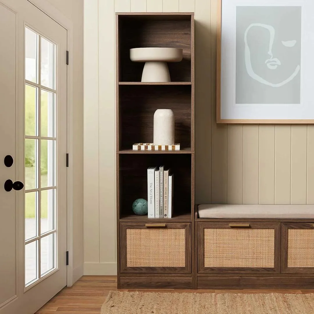 Dark timber bookshelves with rattan drawers at the bottom for entryway storage