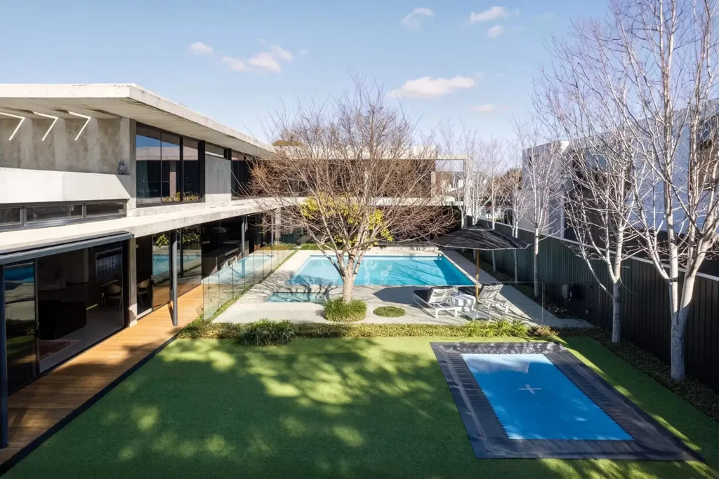 North-facing swimming pool, garden and sports court at the Bali Body founders' Brighton home.