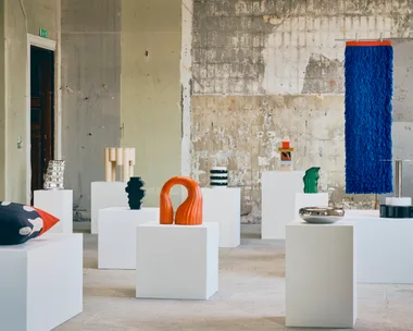 IKEA KONSTRUNDA sculptures, vessels, cushions and colourful textile artworks arranged on white plinths in an industrial gallery setting