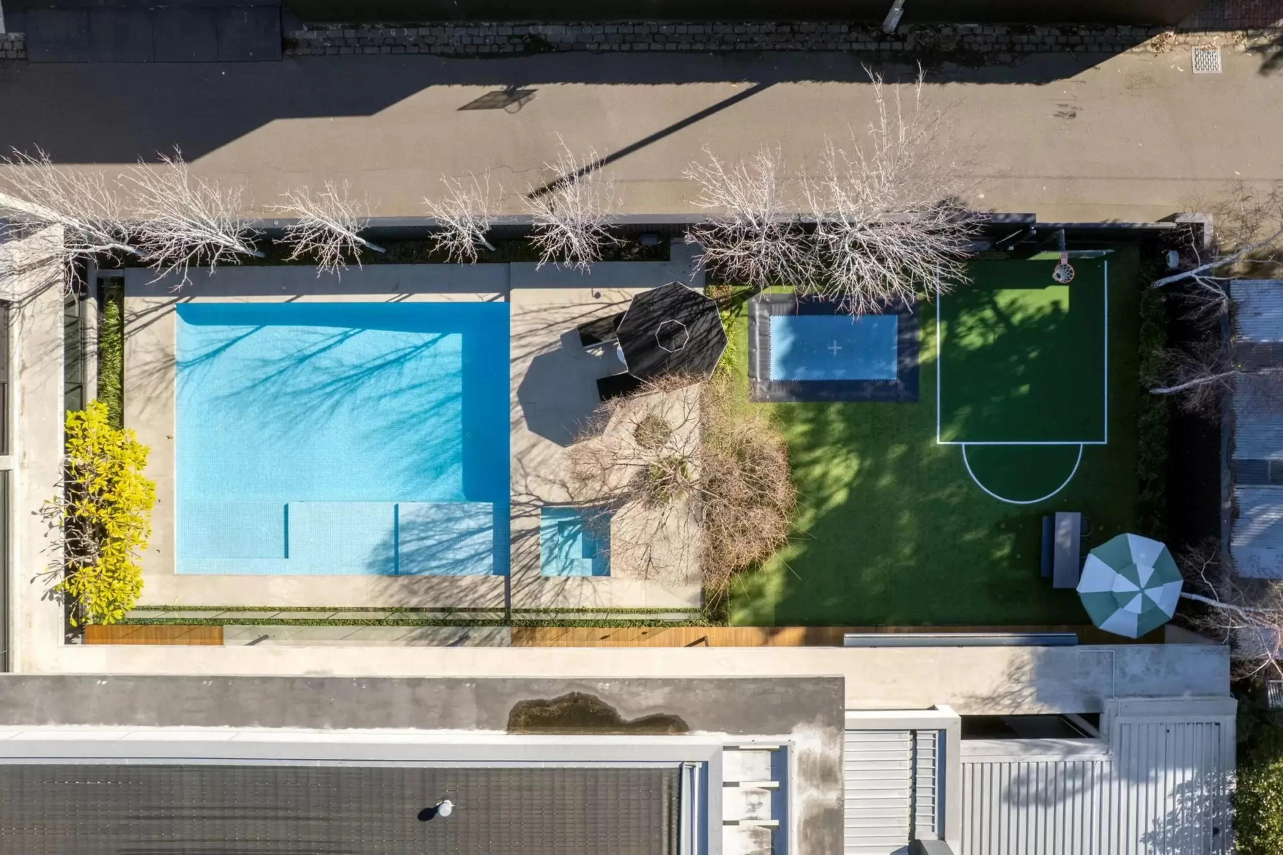 Aerial view of the swimming pool, lawn and sports court at the Brighton home. Bali Body founders' Brighton home