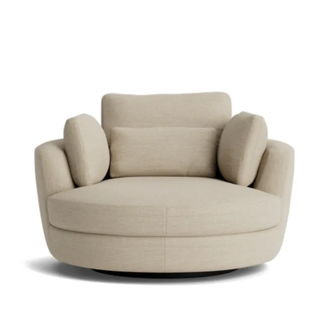 Round swivel chair from nick scali with broad circular seat and low arms and back with additional arm cushions