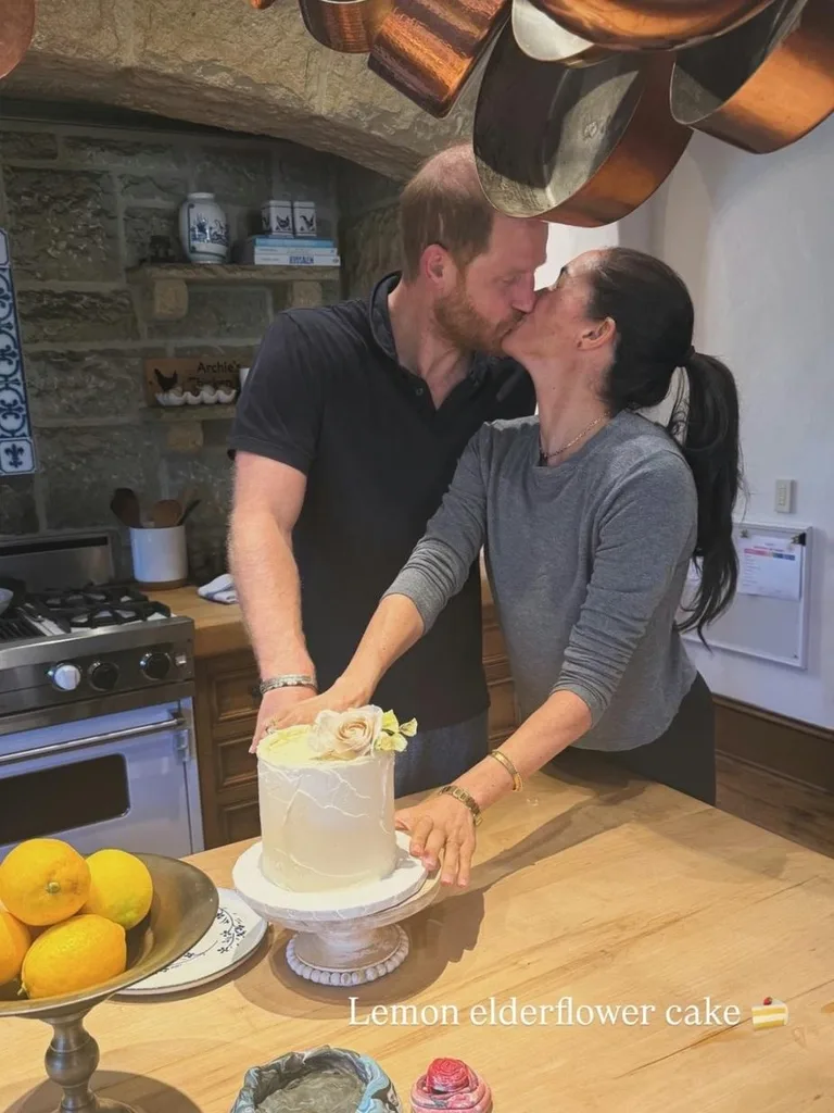 Meghan Markle and Prince Harry kiss beside a birthday cake in their rustic Montecito kitchen.