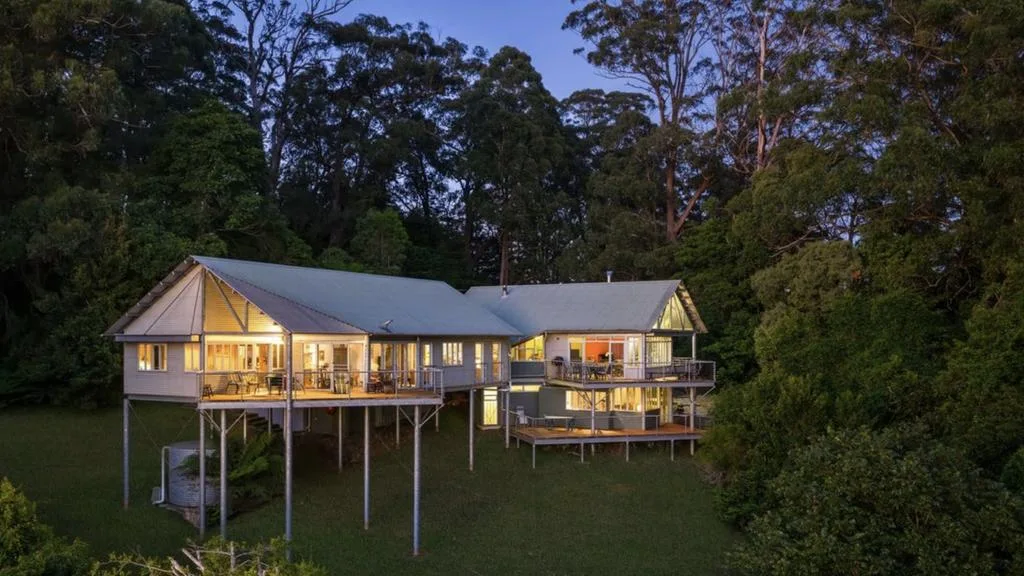 Architect-designed Southern Highlands home elevated among native bushland with multiple timber decks.
