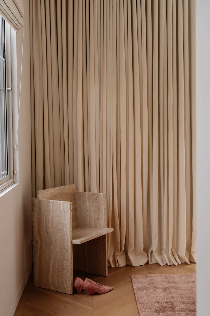 Beige curtains draping from ceiling to floor