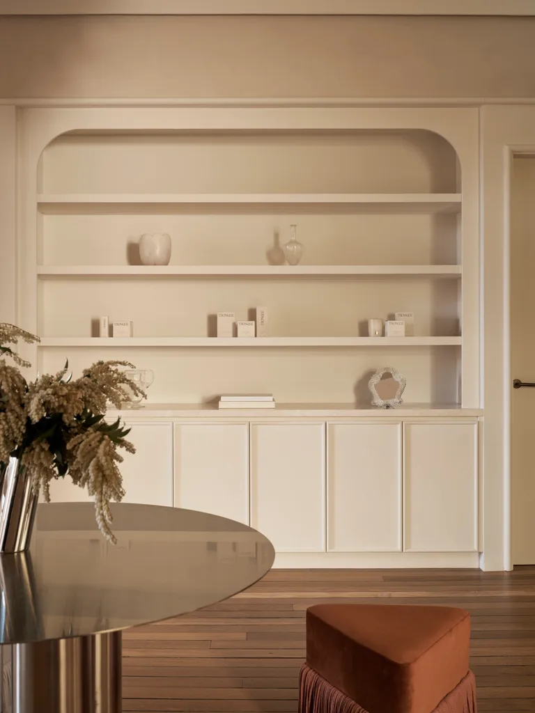 Diandra Politano's studio with creamy joinery next to a round table and vase