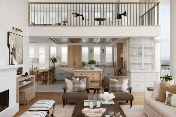Modern open-concept living room and kitchen with a mezzanine, neutral tones, and elegant furnishings.