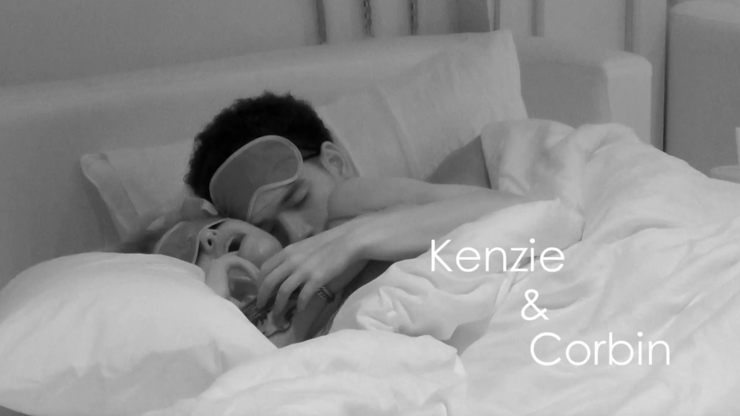 Two people cuddling in bed, caught on a night-vision camera. This is a screengrab from Love Island USA season 8.