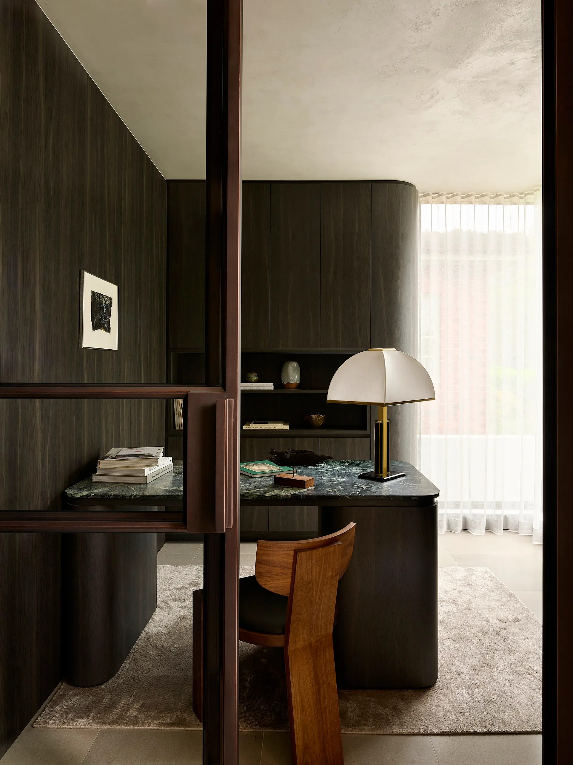 Sydney&rsquo;s Inner West, by Stanton Architects, is a study in chic, thanks to walls in moody timber veneer, a green marble desktop and a sculptural De La Espada &lsquo;Vega&rsquo; chair from Winnings
