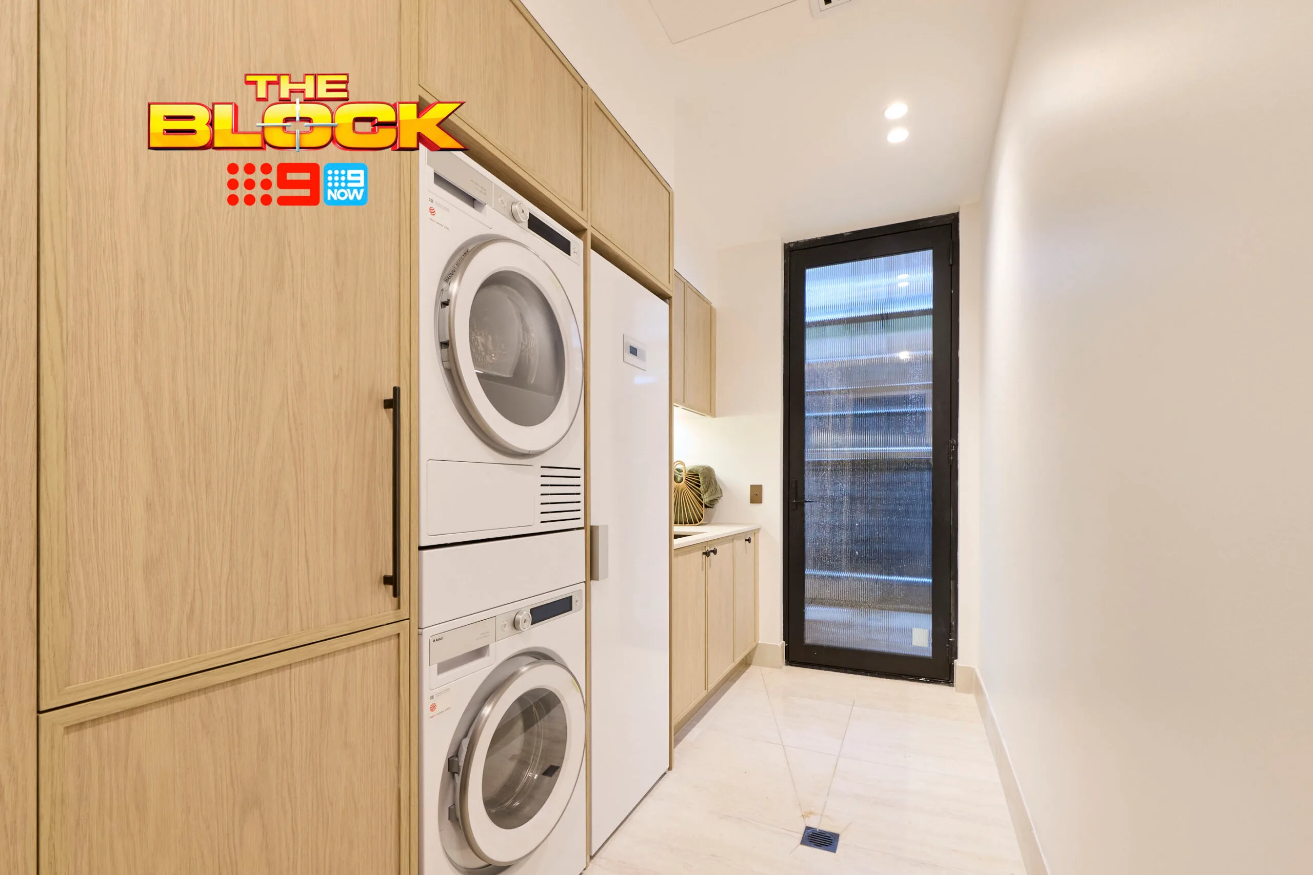 Adam and Jolene's laundry with a washer and drier in cabinetry