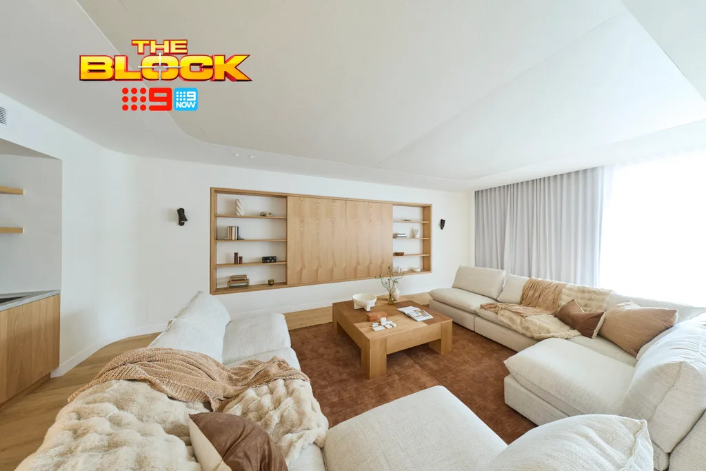 Courtney and Sev's rumpus with timber TV cabinet doors, brown rug and cream couches