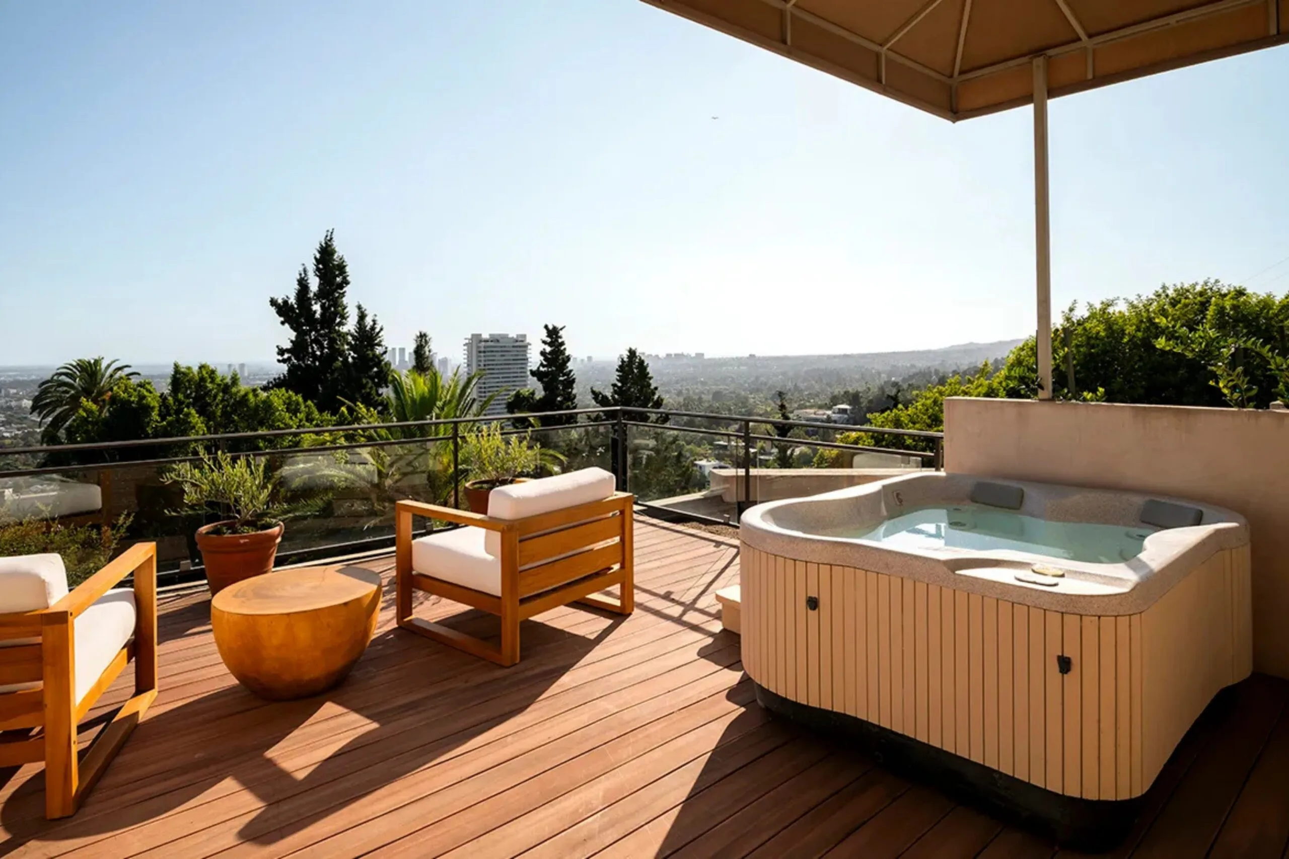 Rooftop deck with wooden chairs, a round table, and a hot tub, overlooking a city skyline under a clear sky.