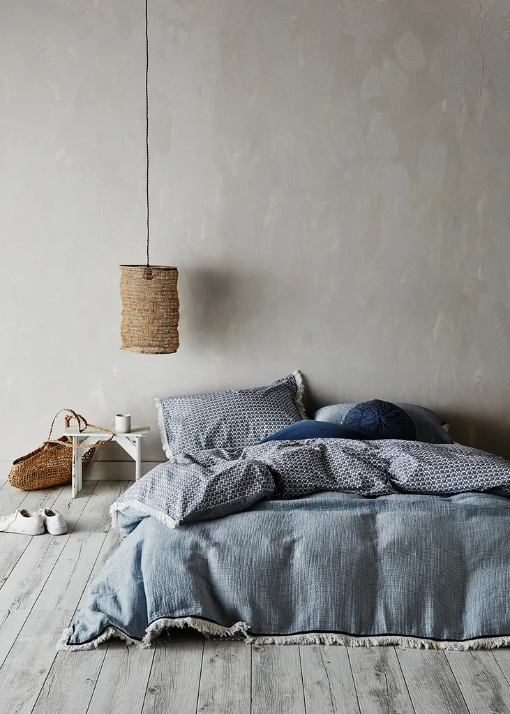 Blue and grey bedroom with woven pendant lamp