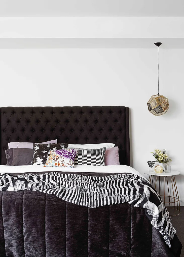 Monochrome bedroom with hints of gleaming gold