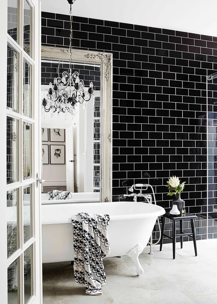 Opulent black and white bathroom with chandelier