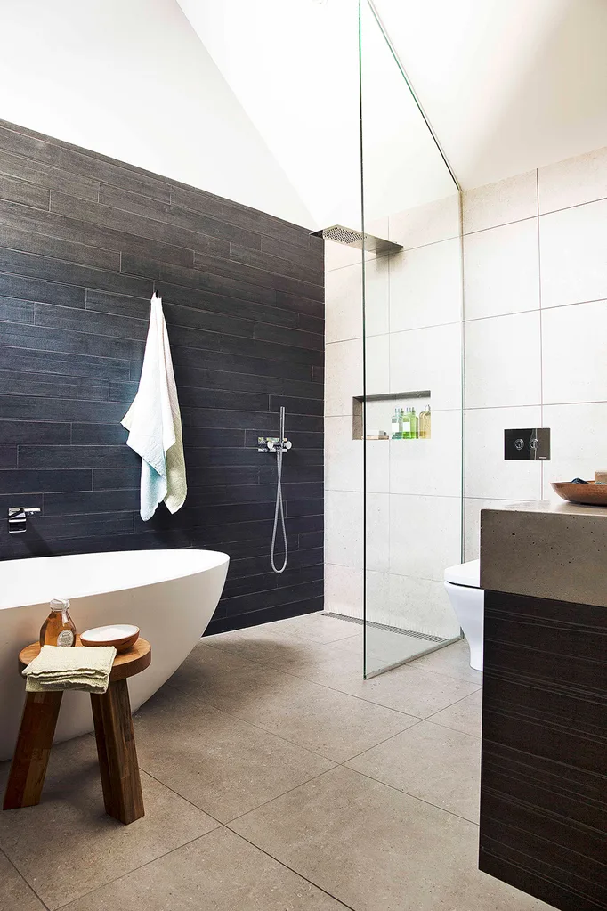 Bathroom with black tiled walls