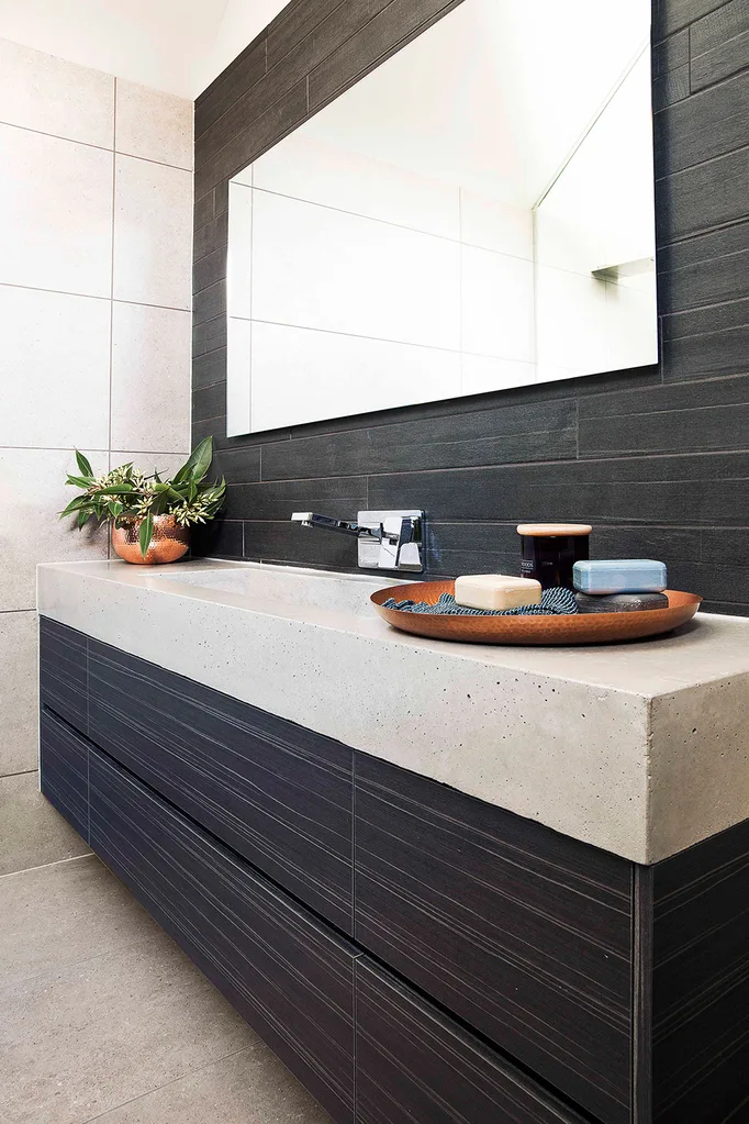 Bathroom vanity with black cabinetry and tiles