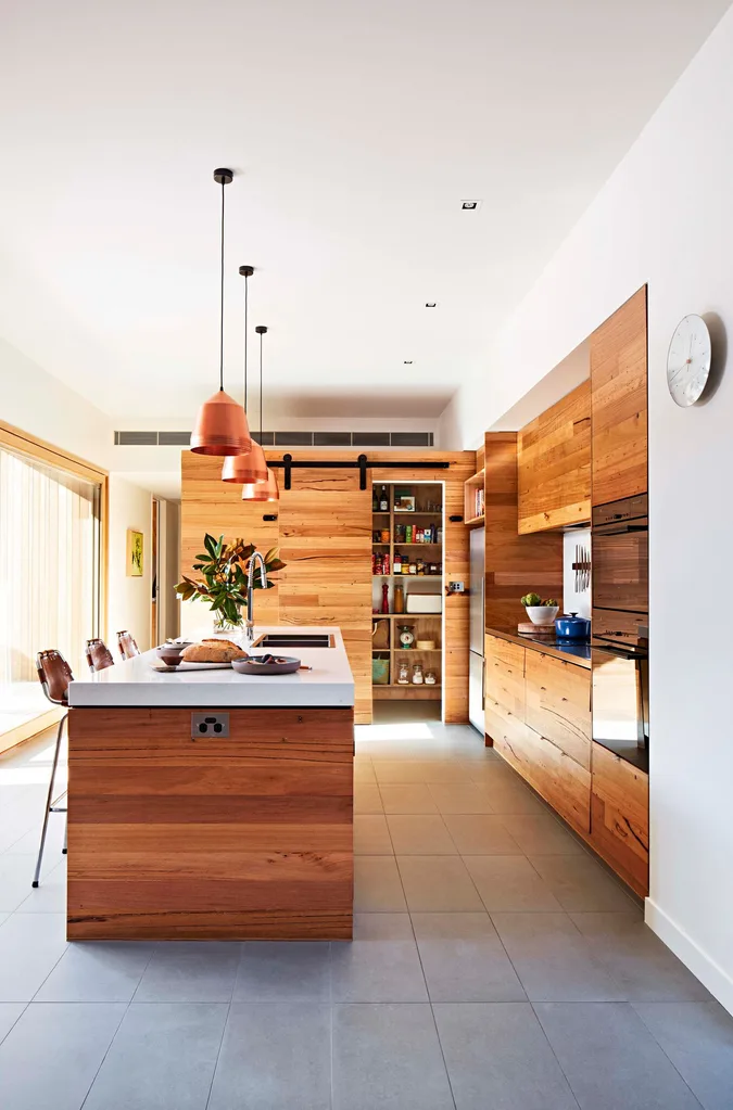 Wood combine with brass in this beautiful, warm kitchen.