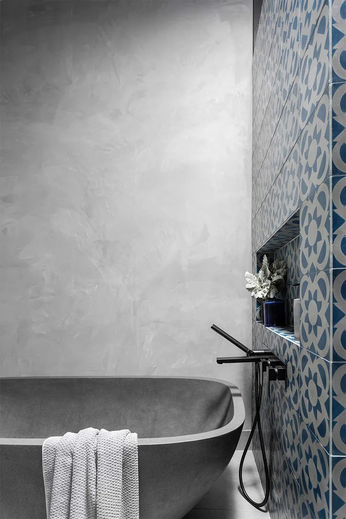 Concrete-look bath and black tapware