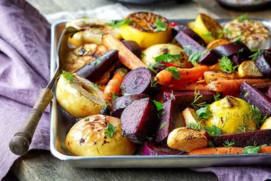 Cut up mixed vegetables on a tray.